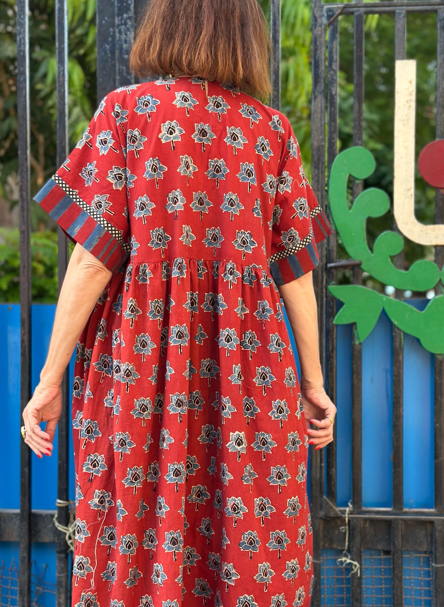 Vintage Kutch embroidery highlights the bodice of this red Ajrakh dress