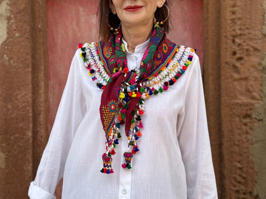 Red mirror embroidered scarf with a fringe of tassels and beadwork.