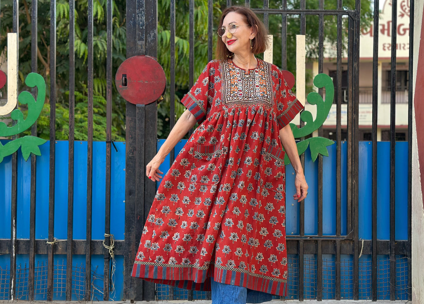 Vintage Kutch embroidery highlights the bodice of this red Ajrakh dress