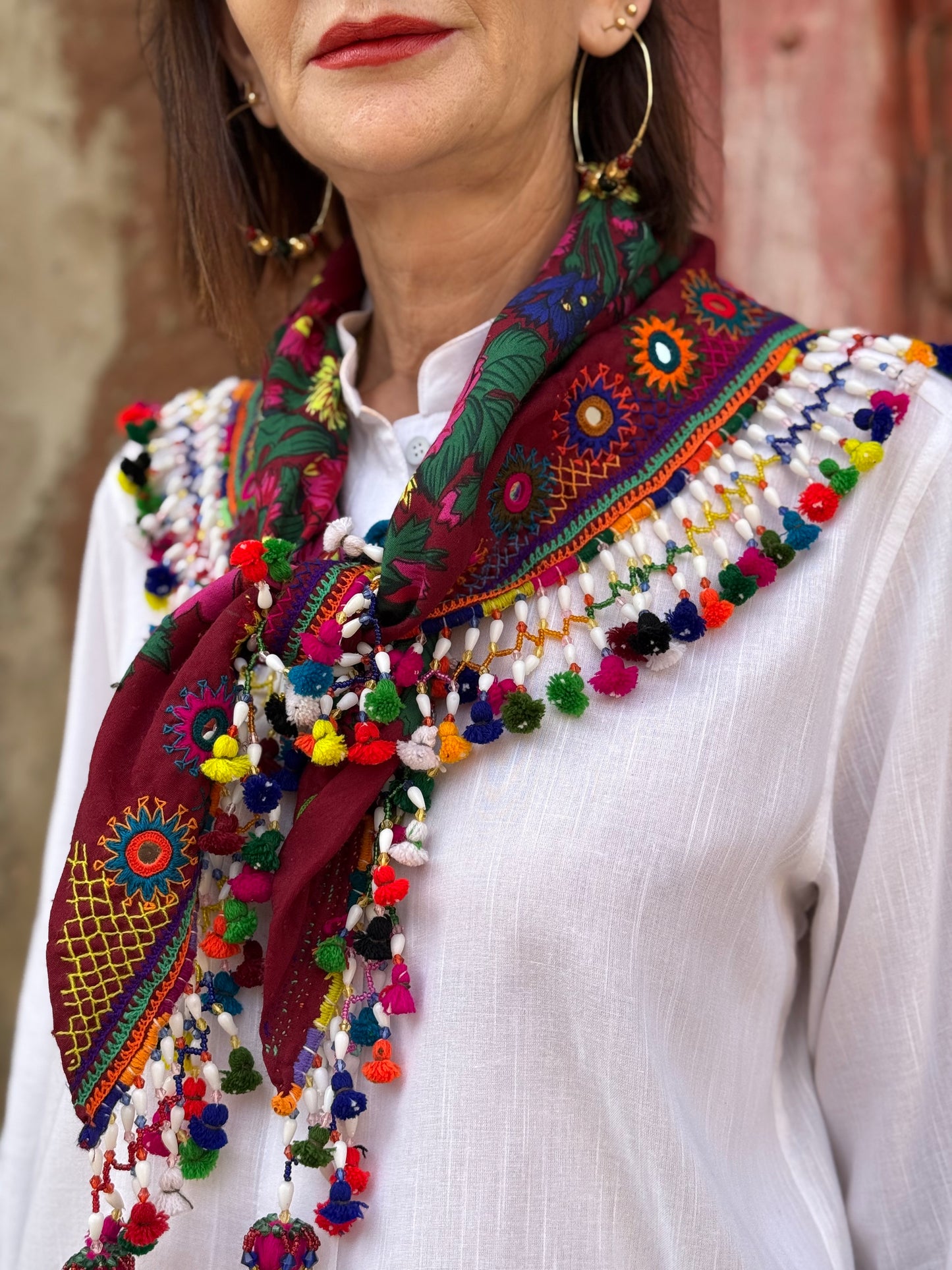 Red mirror embroidered scarf with a fringe of tassels and beadwork.