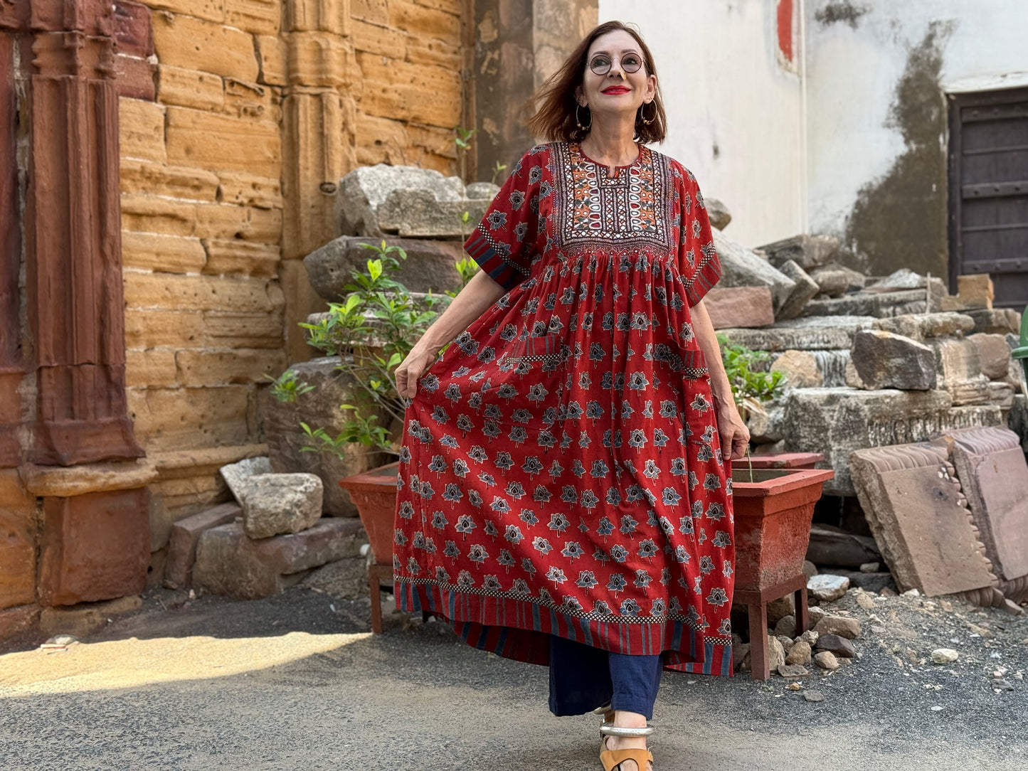 Vintage Kutch embroidery highlights the bodice of this red Ajrakh dress