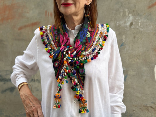Black embroidered floral scarf with a fringe of colorful tassels and beadwork.
