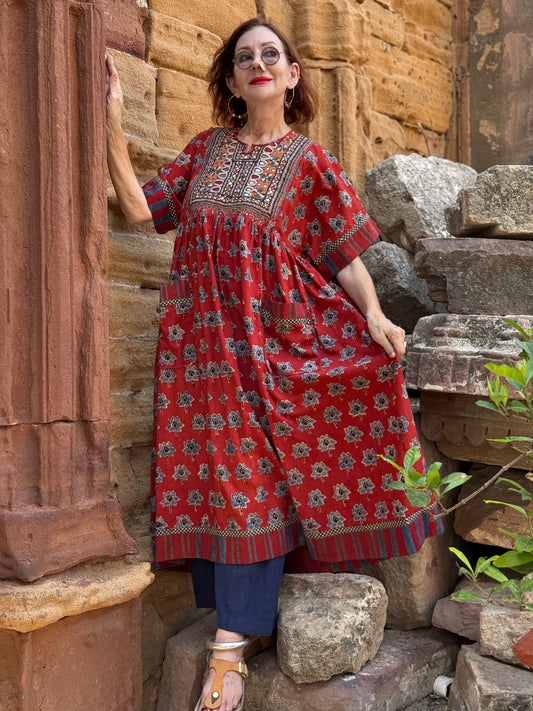 Vintage Kutch embroidery highlights the bodice of this red Ajrakh dress