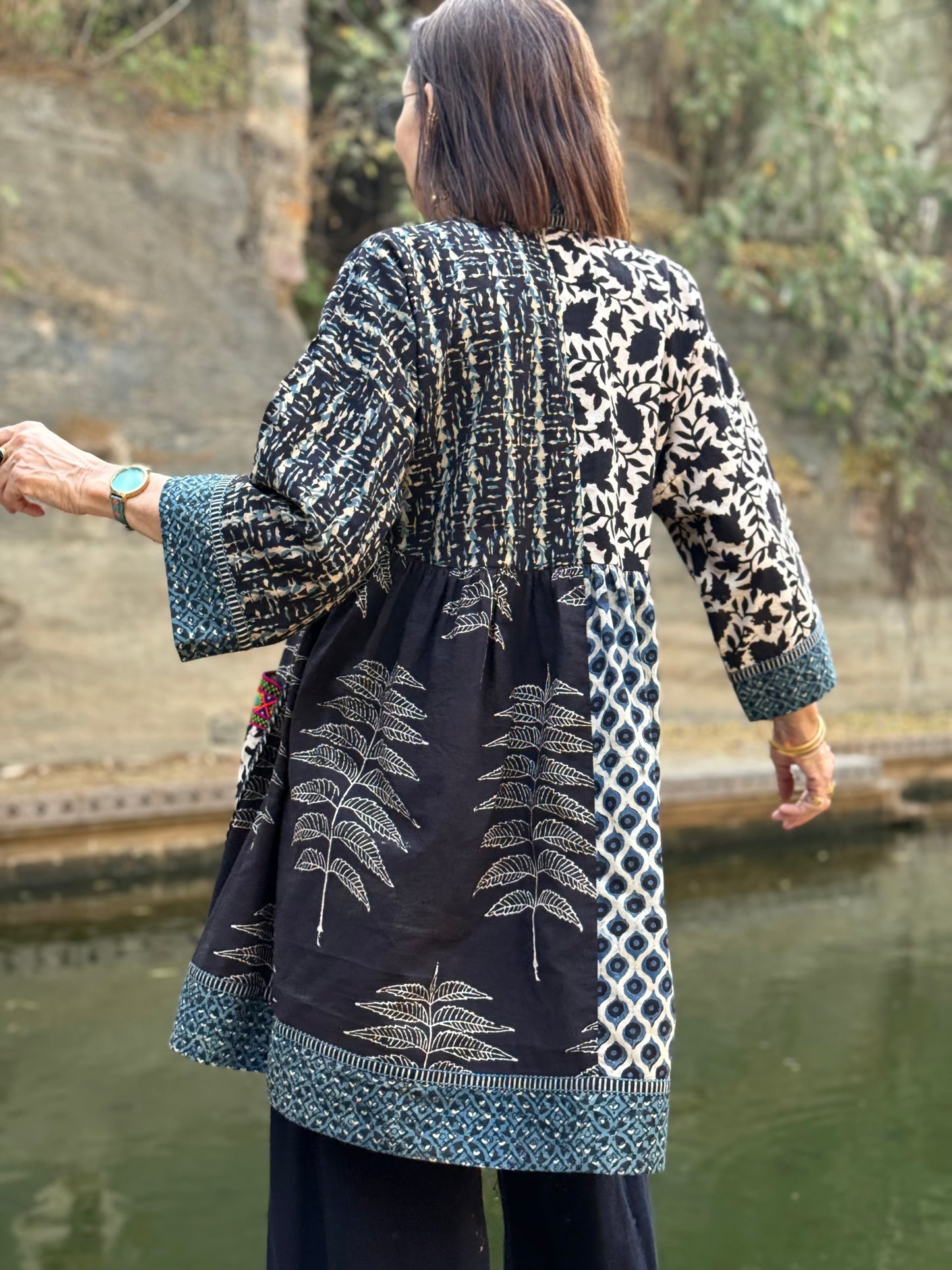 Colorful Kutch hand embroidery decorates this Cotton Tunic in a mixed print design of hand printed Ajrakh.