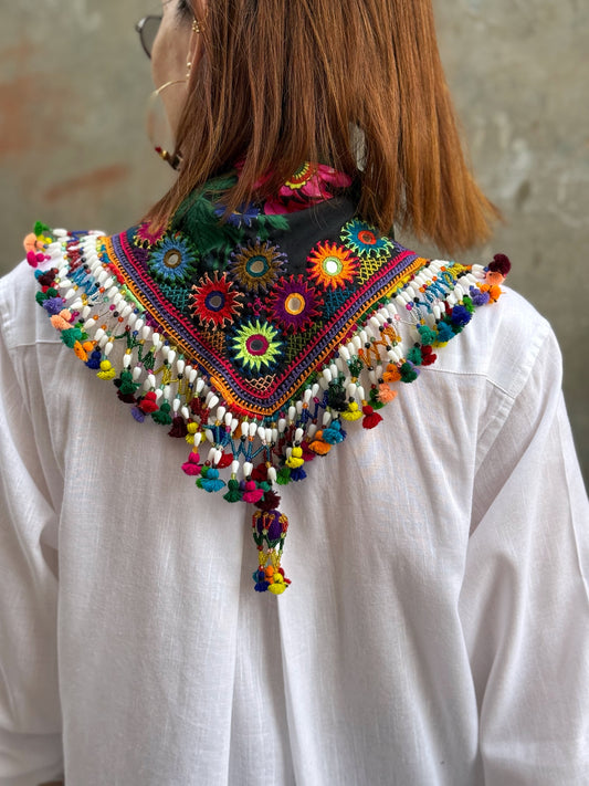 Black embroidered floral scarf with a fringe of colorful tassels and beadwork.