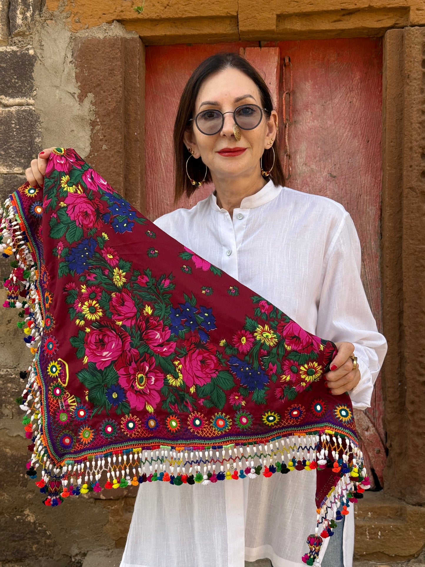 Red mirror embroidered scarf with a fringe of tassels and beadwork.