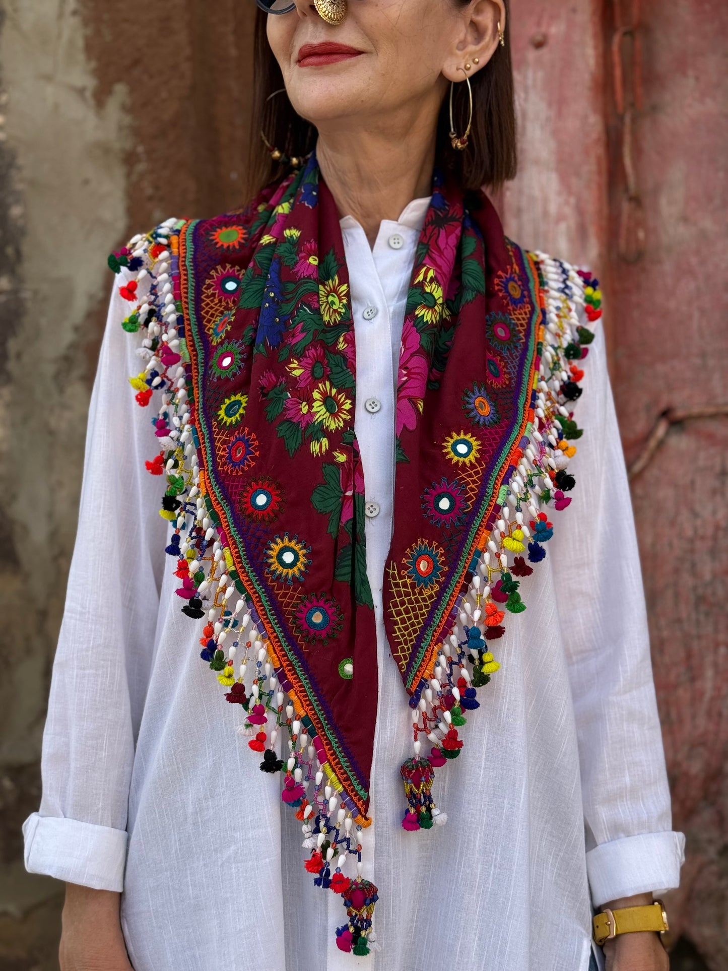 Red mirror embroidered scarf with a fringe of tassels and beadwork.