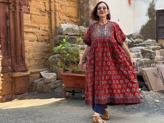 Vintage Kutch embroidery highlights the bodice of this red Ajrakh dress