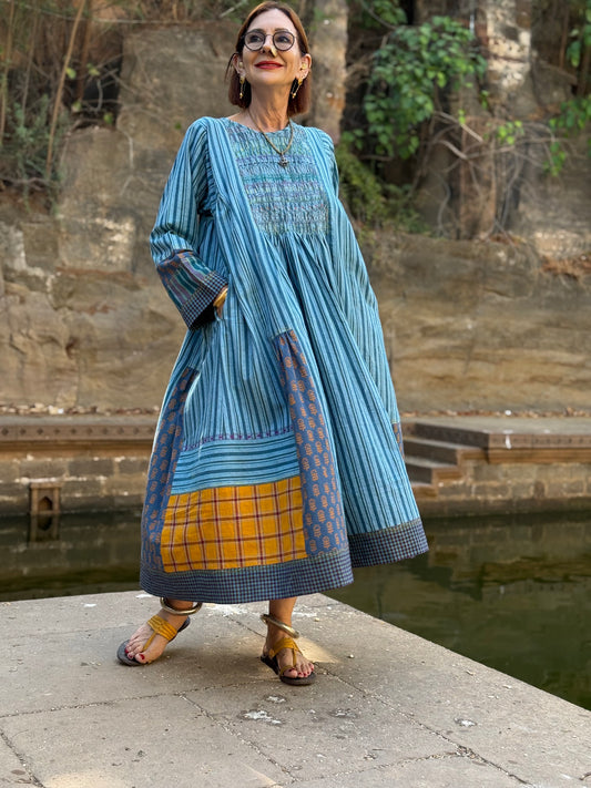 Blue striped Khadi cotton dress with designer patchwork and smocked embroidery bodice.