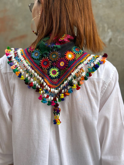 Black embroidered floral scarf with a fringe of colorful tassels and beadwork.
