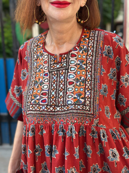 Vintage Kutch embroidery highlights the bodice of this red Ajrakh dress