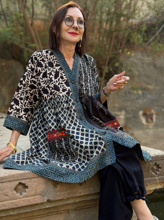Colorful Kutch hand embroidery decorates this Cotton Tunic in a mixed print design of hand printed Ajrakh.