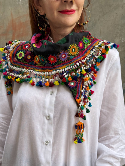 Black embroidered floral scarf with a fringe of colorful tassels and beadwork.