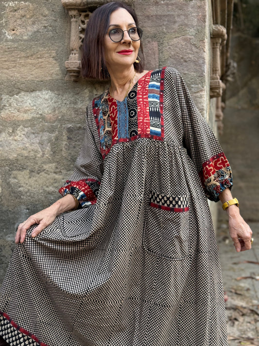 Indian style dress from fine cotton. Block printed, and with hand embroidered mirrors, the bib and sleeves contrast fabric, color and print