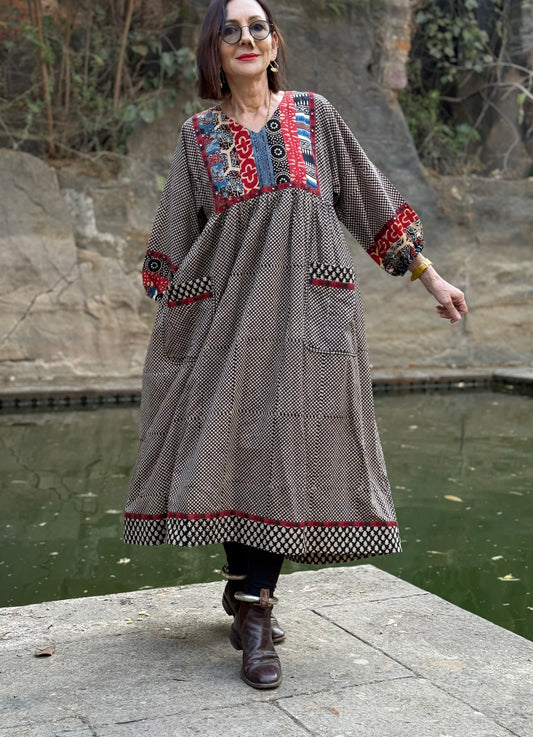 Indian style dress from fine cotton. Block printed, and with hand embroidered mirrors, the bib and sleeves contrast fabric, color and print